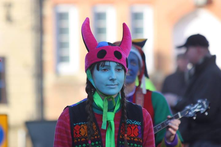 Closeup of a dancer with a hat with two horns